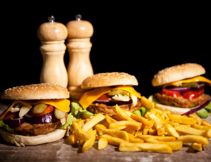 Burgers and fries on black background